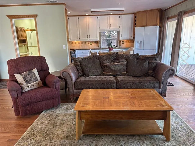 a kitchen with a table chairs refrigerator and microwave