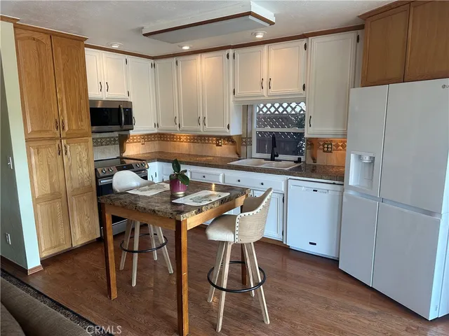 a kitchen with stainless steel appliances a microwave a sink and cabinets