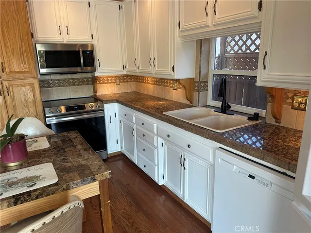 a kitchen with a refrigerator and window