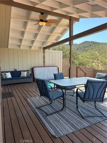 a view of a balcony with wooden floor and outdoor seating