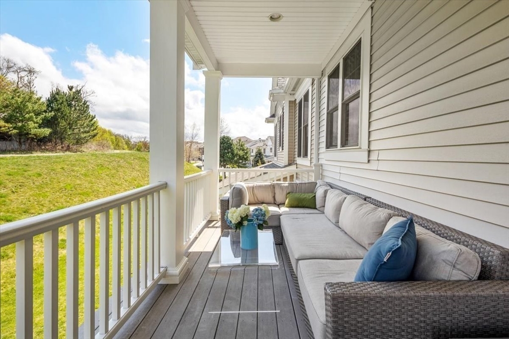 159 Hms Stayner Drive, Unit 159 Hingham, MA 02043 - Photo 14 of 35 a view of balcony with couch and wooden floor