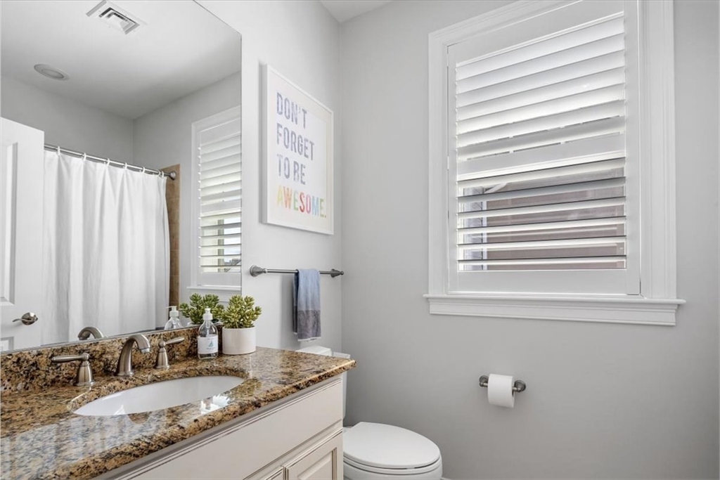 159 Hms Stayner Drive, Unit 159 Hingham, MA 02043 - Photo 19 of 35 a bathroom with a granite countertop sink toilet and mirror