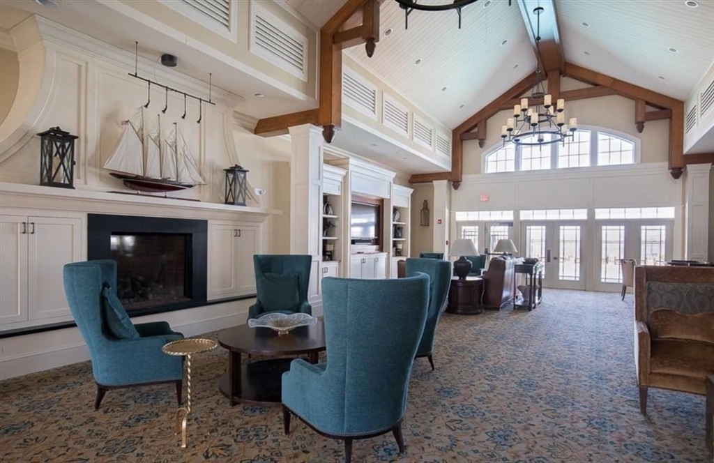 159 Hms Stayner Drive, Unit 159 Hingham, MA 02043 - Photo 31 of 35 a living room with furniture a fireplace and a large window