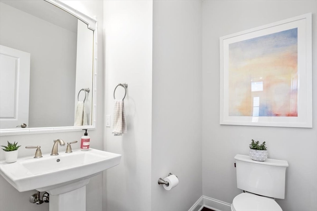 159 Hms Stayner Drive, Unit 159 Hingham, MA 02043 - Photo 9 of 35 a bathroom with a toilet sink and mirror