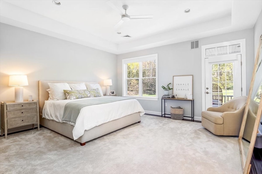 159 Hms Stayner Drive, Unit 159 Hingham, MA 02043 - Photo 10 of 35 a spacious bedroom with a bed and a couch