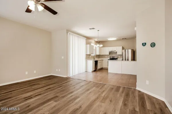 a kitchen with kitchen island a counter top space a sink stainless steel appliances and a window
