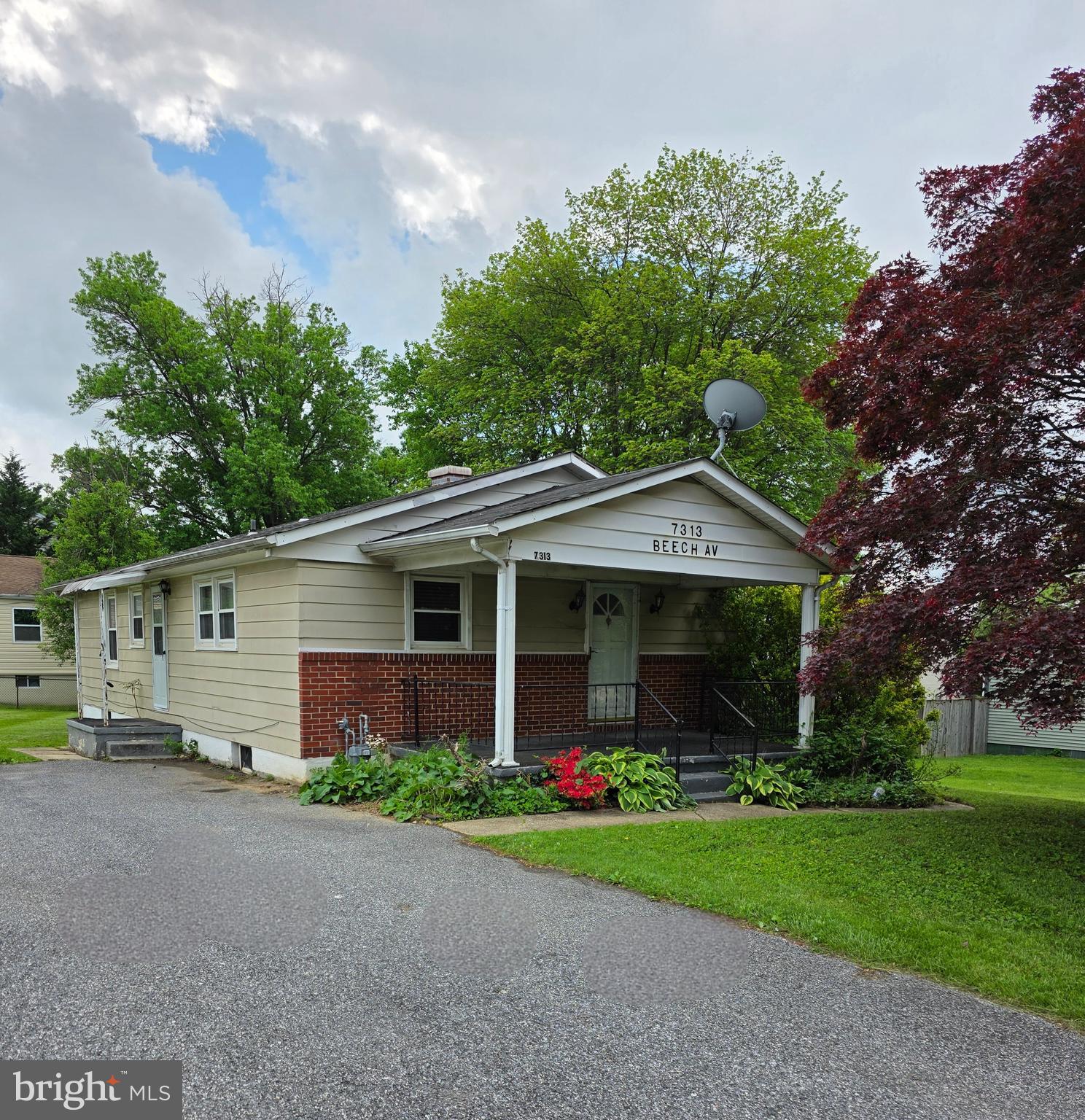 7313 Beech Avenue Baltimore, MD 21206 - Photo 1 of 17 a front view of house with yard and green space