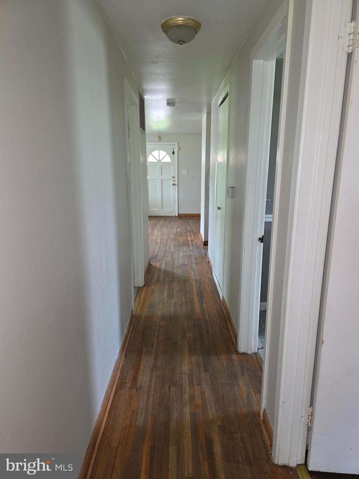 7313 Beech Avenue Baltimore, MD 21206 - Photo 13 of 17 a view of a hallway with wooden floor