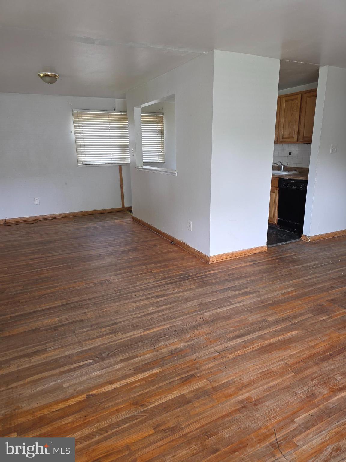 7313 Beech Avenue Baltimore, MD 21206 - Photo 5 of 17 wooden floor in an empty room with a window