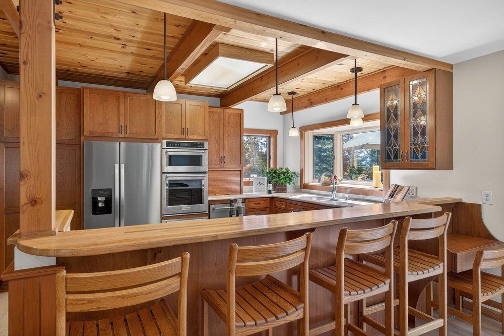 12964 Falcon Point Place Truckee, CA 96161 - Photo 11 of 28 a dining hall with stainless steel appliances granite countertop a stove and a refrigerator