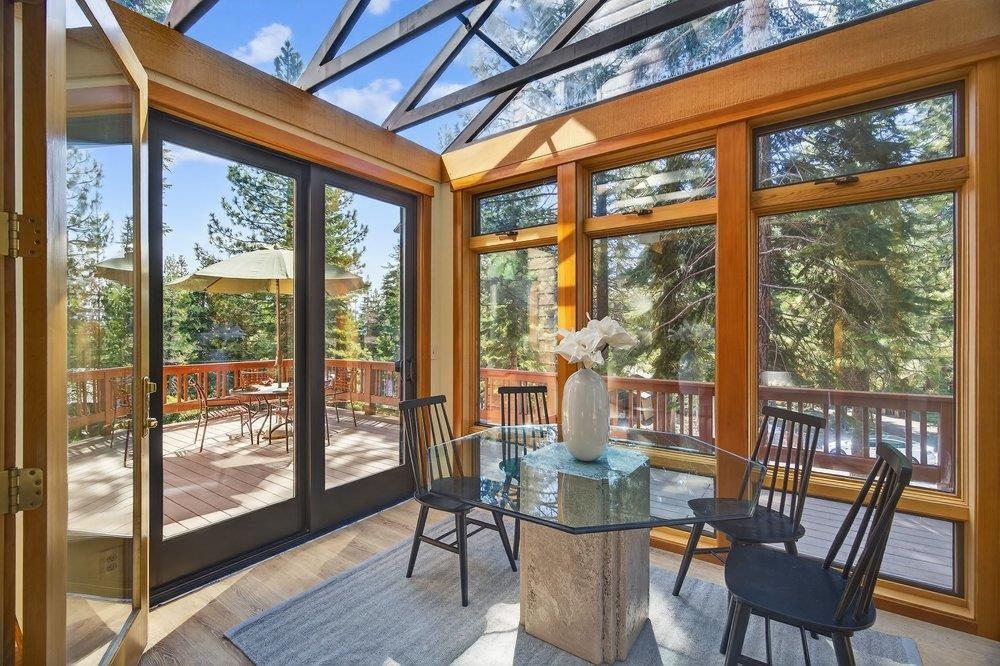 12964 Falcon Point Place Truckee, CA 96161 - Photo 16 of 28 a dining room with a glass top table and chairs