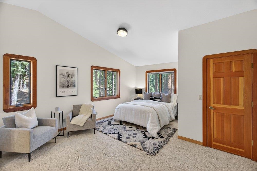 12964 Falcon Point Place Truckee, CA 96161 - Photo 23 of 28 a spacious bedroom with a bed and a couch