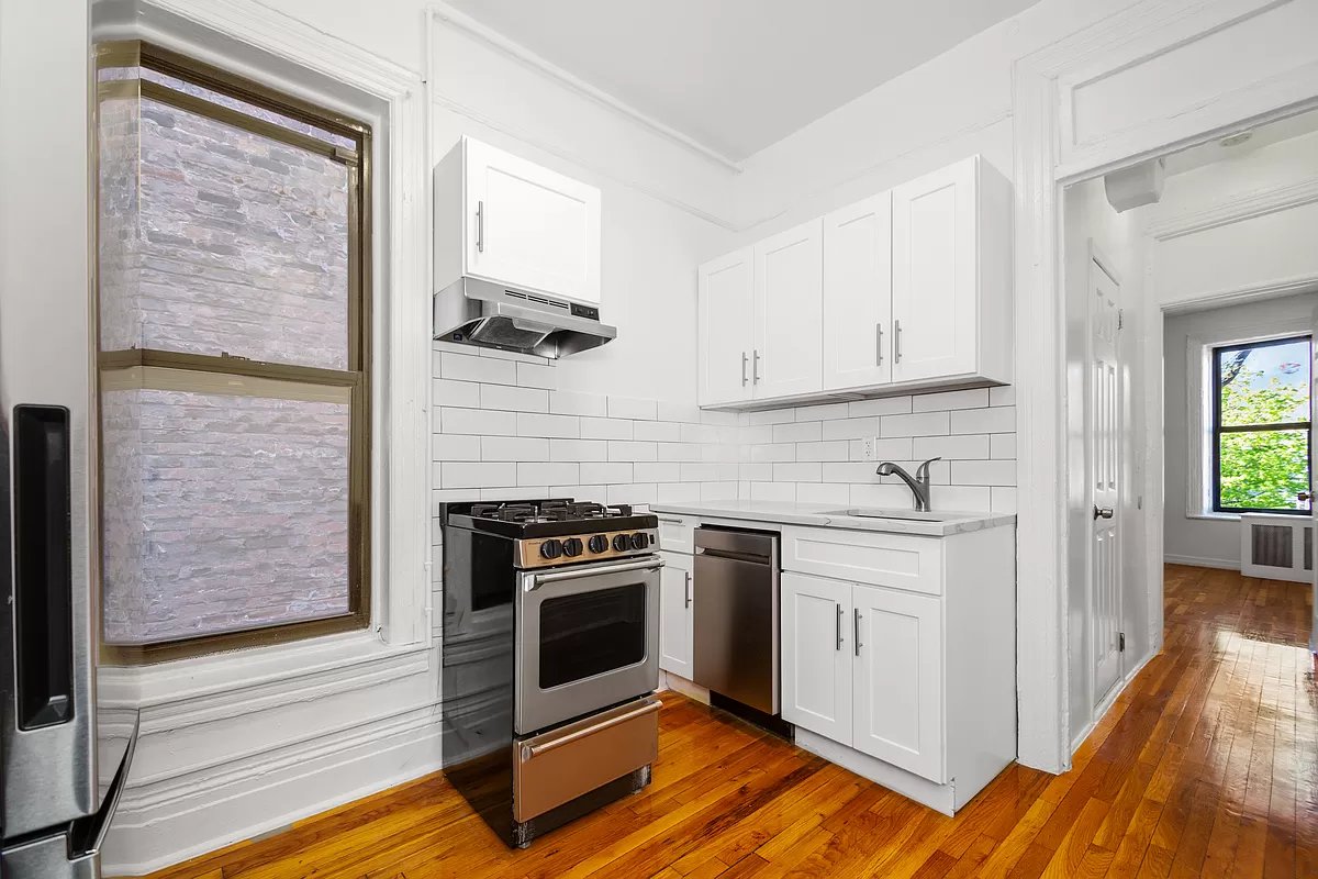a kitchen with a stove and a white cabinet