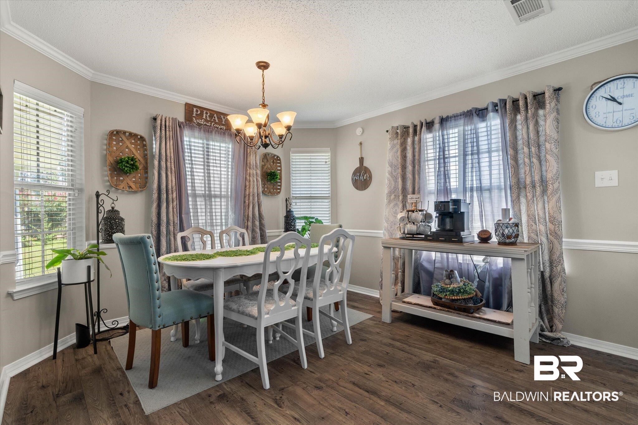 8600 Sable Court Semmes, AL 36575 - Photo 8 of 20 Dining space featuring wood finished floors, a chandelier, plenty of natural light, crown molding, and a textured ceiling