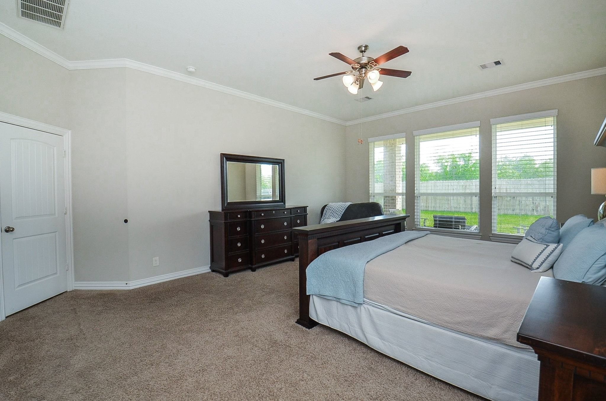 2714 Topaz Cove Lane Rosharon, TX 77583 - Photo 24 of 50 a spacious bedroom with a bed and a large window