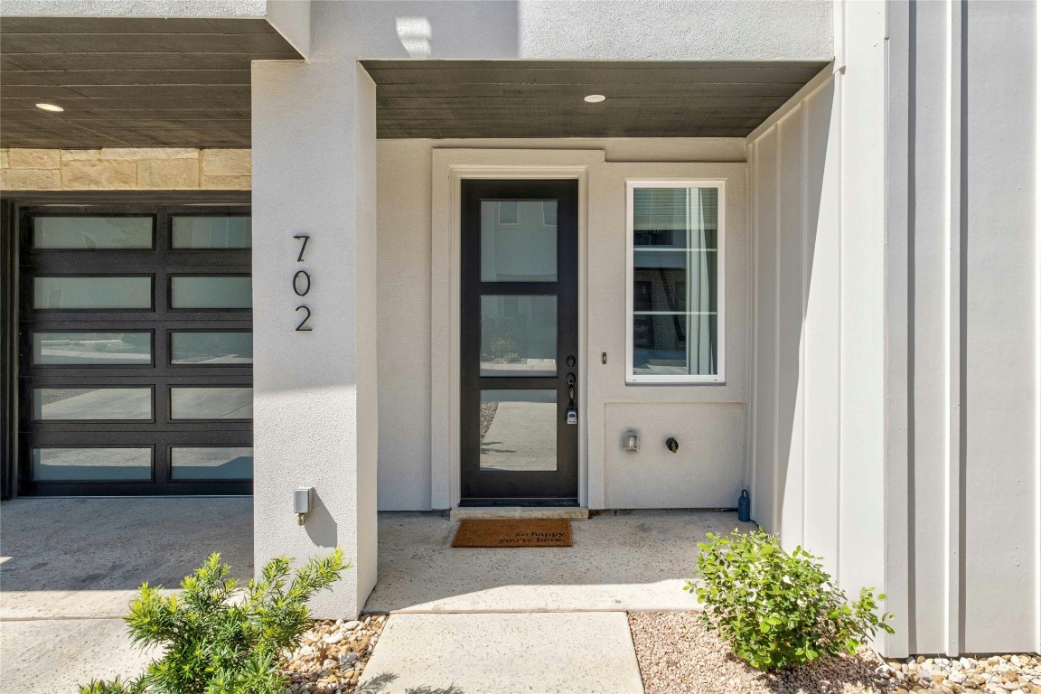 12001 Vista Parke Drive, Unit 702 Austin, TX 78726 - Photo 1 of 33 a front view of a house with a garden