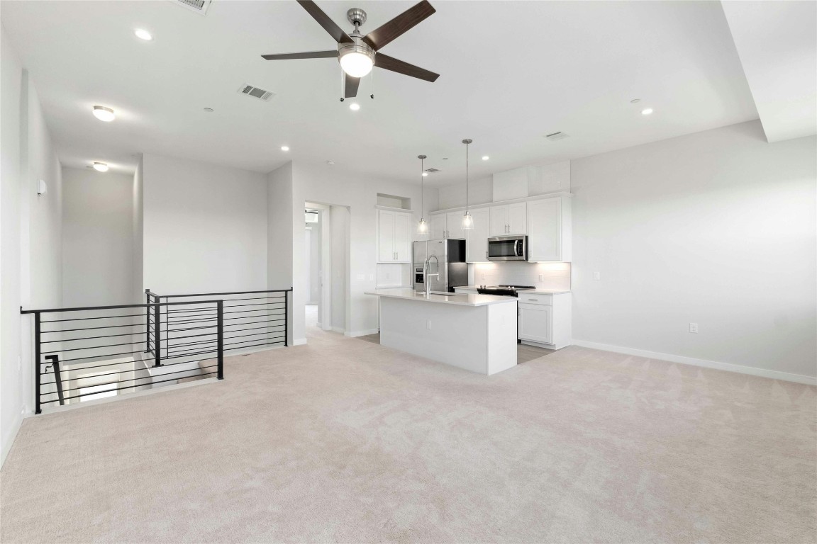 12001 Vista Parke Drive, Unit 702 Austin, TX 78726 - Photo 11 of 33 a view of a kitchen with refrigerator and a sink