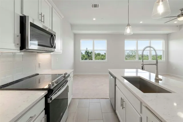 a kitchen with a sink and a microwave