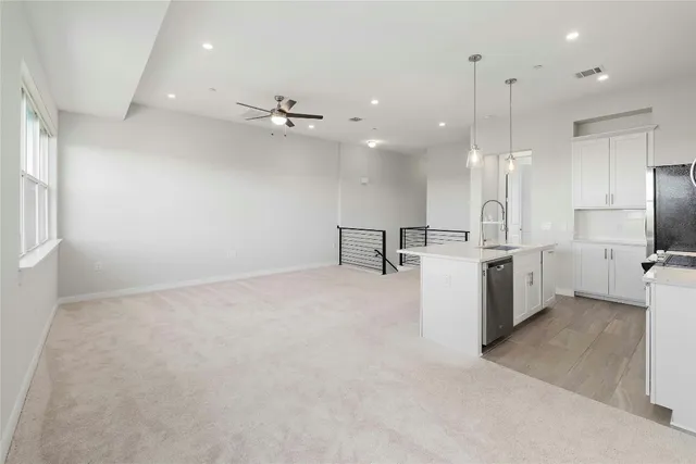 a view of a kitchen with a sink and a refrigerator