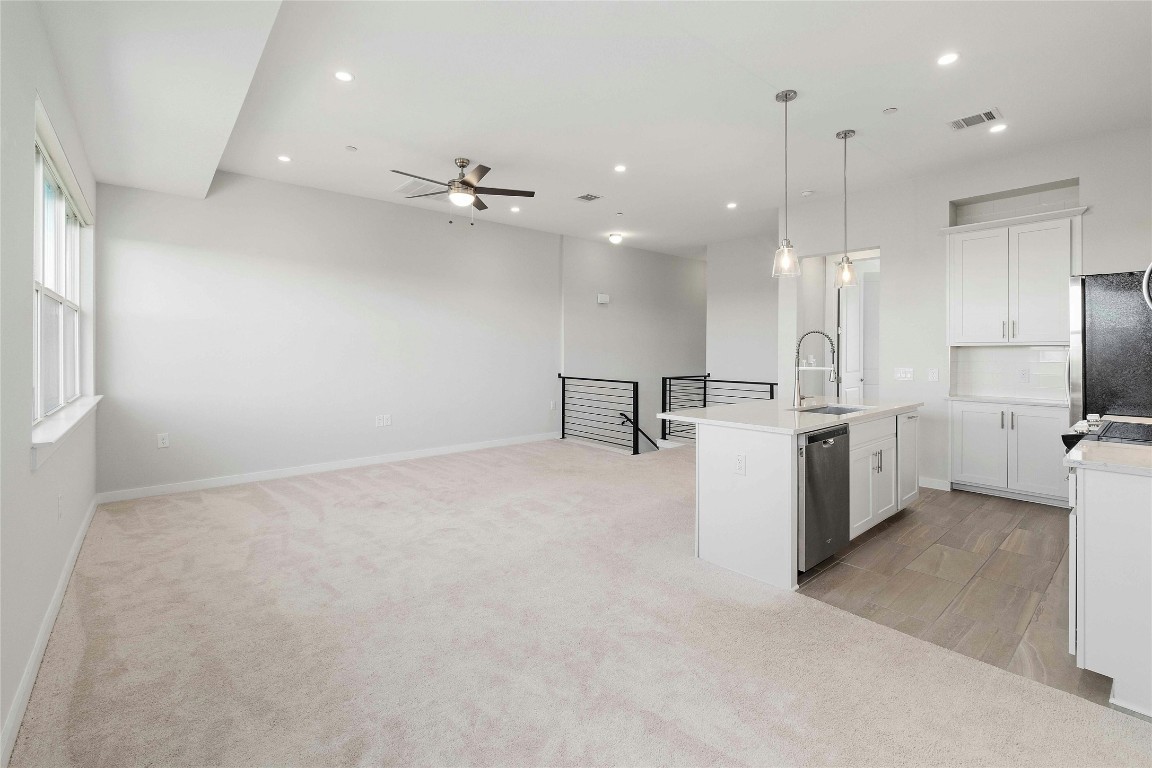 12001 Vista Parke Drive, Unit 702 Austin, TX 78726 - Photo 15 of 33 a view of a kitchen with a sink and a refrigerator