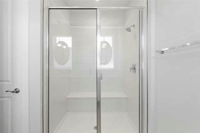 a bathroom with a glass shower door