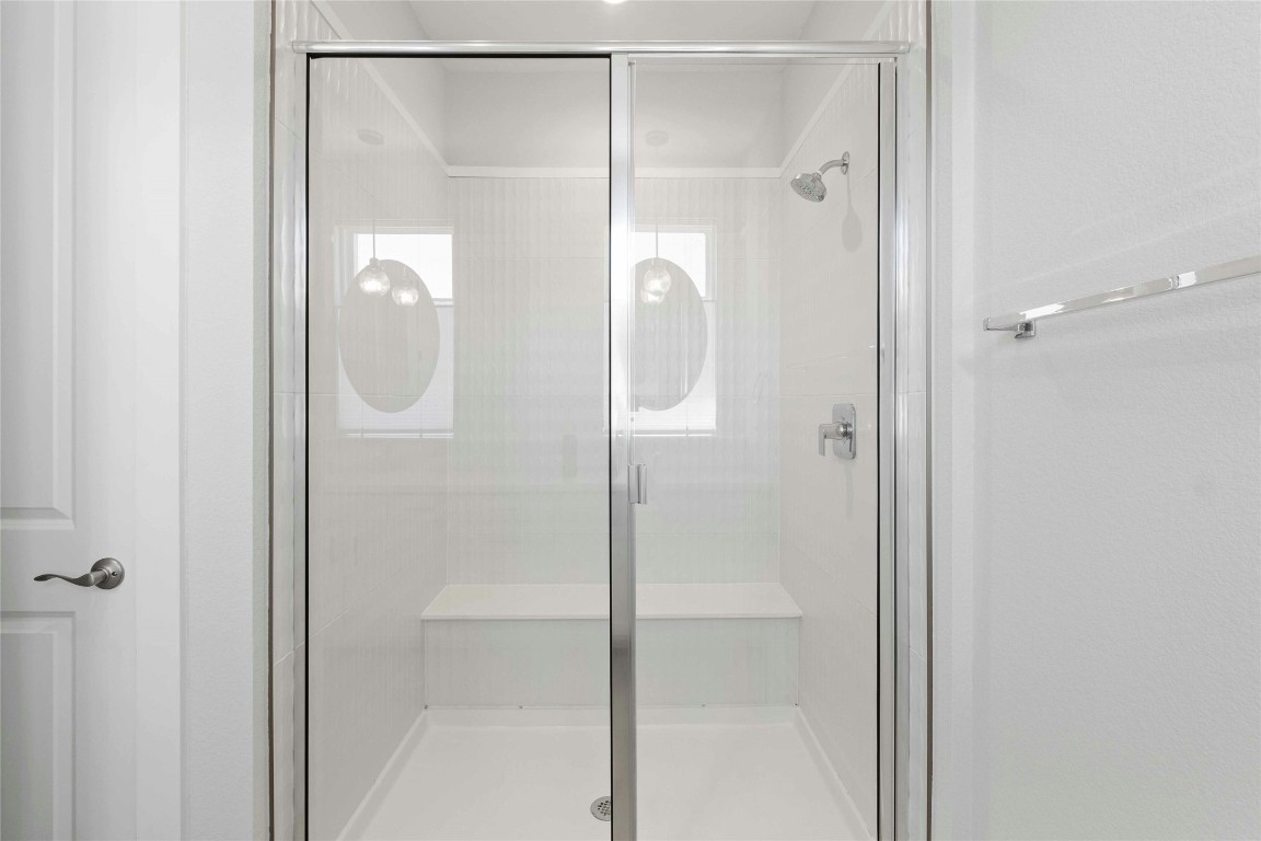 12001 Vista Parke Drive, Unit 702 Austin, TX 78726 - Photo 19 of 33 a bathroom with a glass shower door