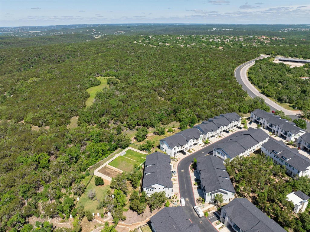 12001 Vista Parke Drive, Unit 702 Austin, TX 78726 - Photo 30 of 33 an aerial view of residential houses with outdoor space and trees