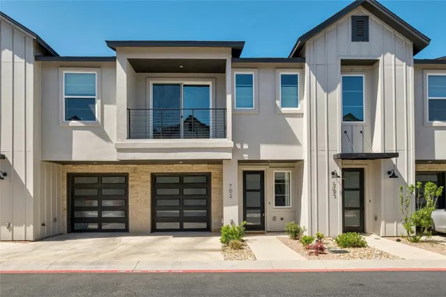 a front view of a house with garage