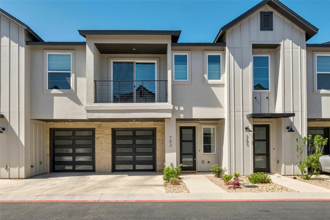 12001 Vista Parke Drive, Unit 702 Austin, TX 78726 - Photo 33 of 33 a front view of a house with garage