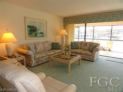 3235 Sugarloaf Key Road, Unit 12A Punta Gorda, FL 33955 - Photo 3 of 8 a living room with furniture and a large window