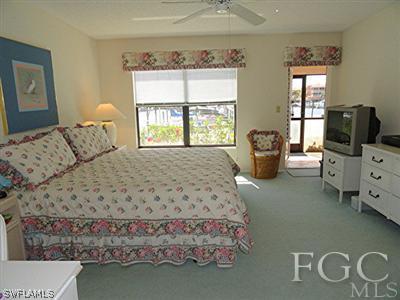 3235 Sugarloaf Key Road, Unit 12A Punta Gorda, FL 33955 - Photo 6 of 8 a bedroom with a bed and wooden floor