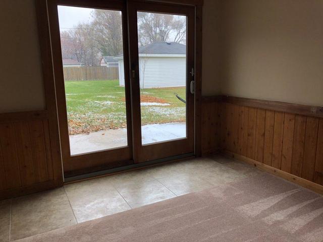 29 Surrey Road Montgomery, IL 60538 - Photo 10 of 26 a view of a big room with wooden floor and windows