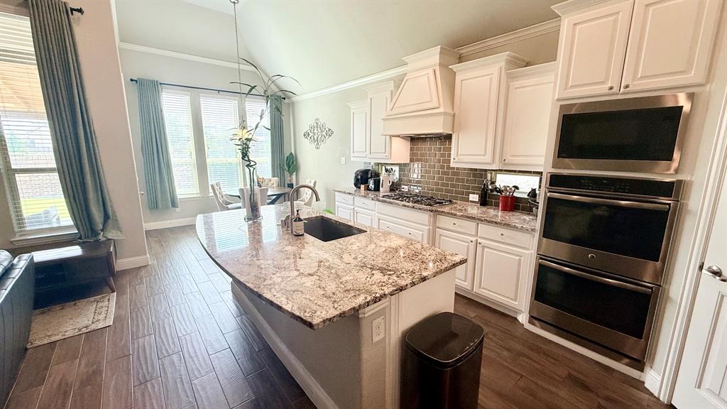 337 Prairie Ridge Lane Lewisville, TX 75056 - Photo 7 of 28 a kitchen with a sink stove and cabinets