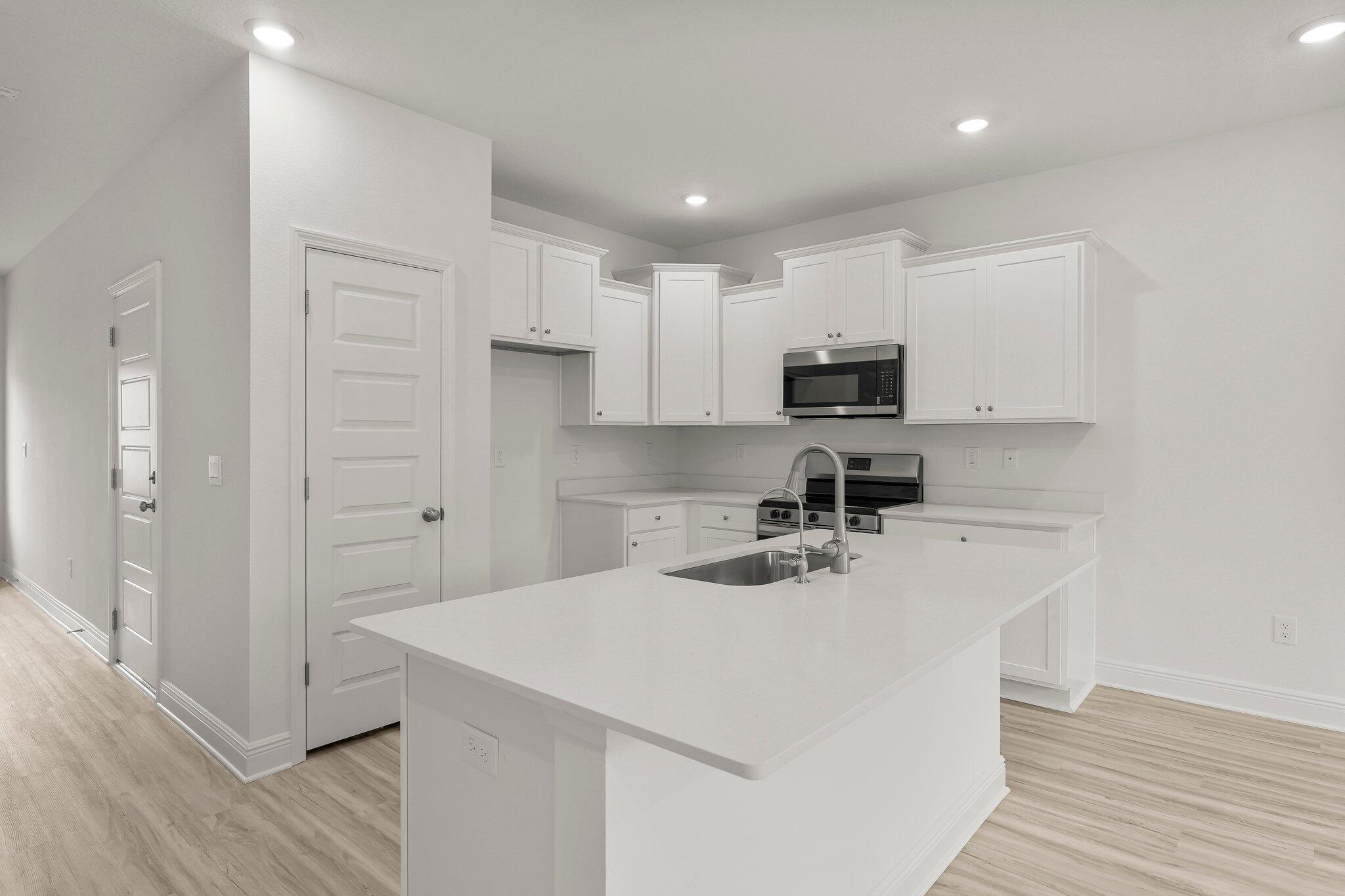 83 Mamba Lane Santa Rosa Beach, FL 32459 - Photo 12 of 34 a kitchen with a sink a stove and cabinets
