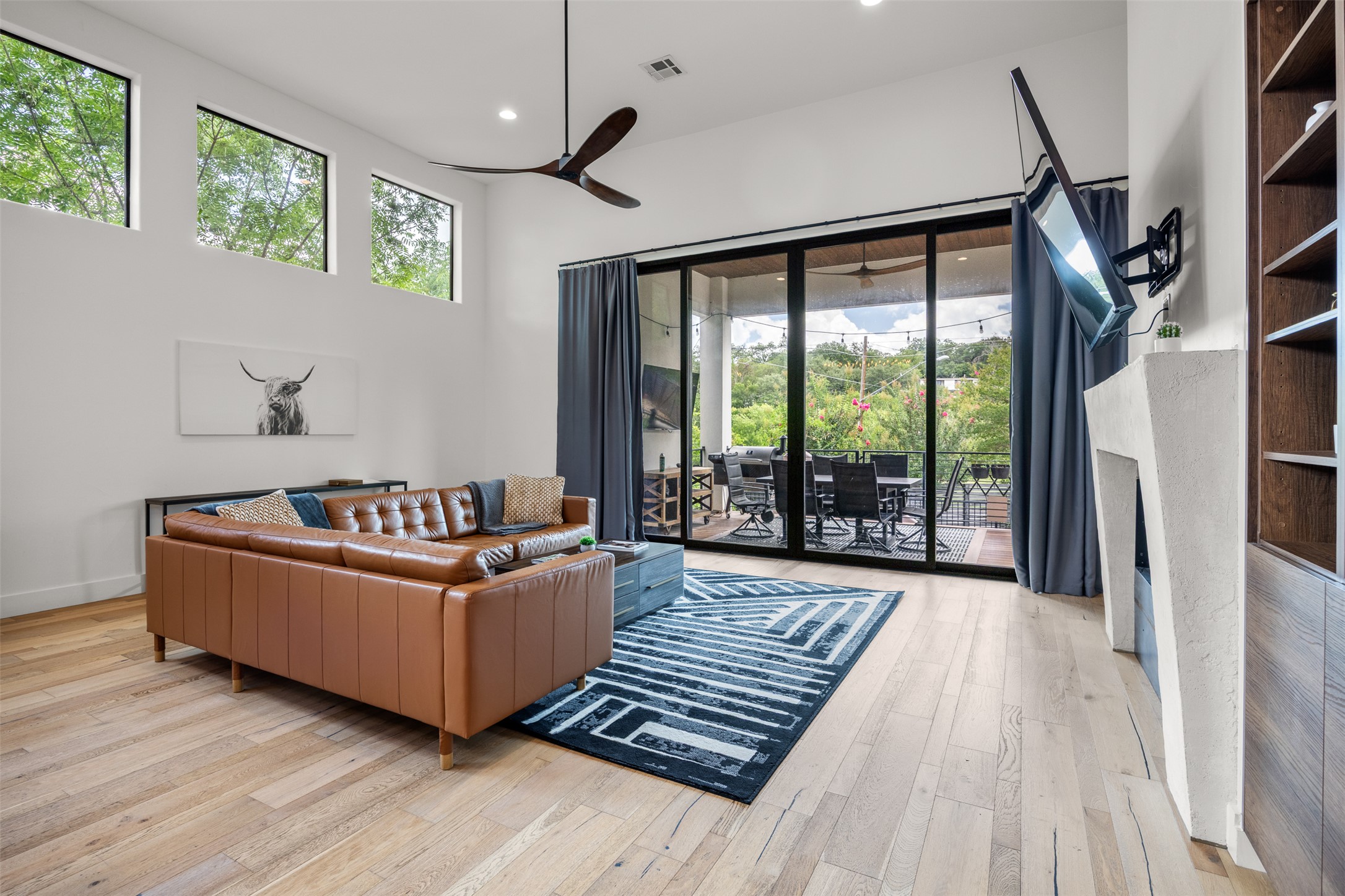 4103 Ridgelea Drive Austin, TX 78731 - Photo 13 of 26 A spacious living area with high ceilings opens to a large private deck, extending the entertainment space.