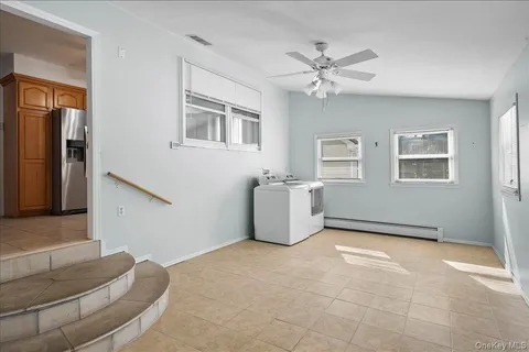 a view of a livingroom with a ceiling fan and window