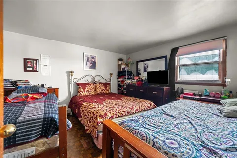 a bedroom with two beds and a flat screen tv