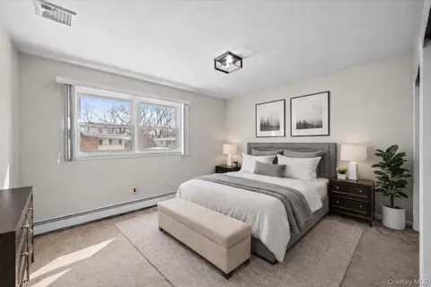a bedroom with a large bed and a window