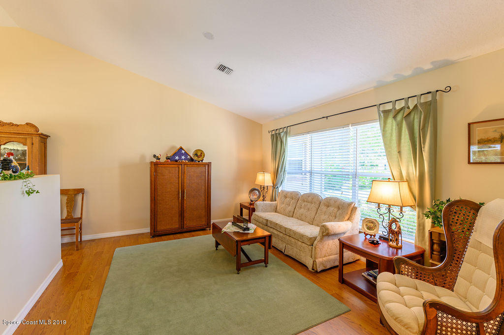 3525 Shady Run Road Melbourne, FL 32934 - Photo 11 of 32 a living room with furniture and a large window