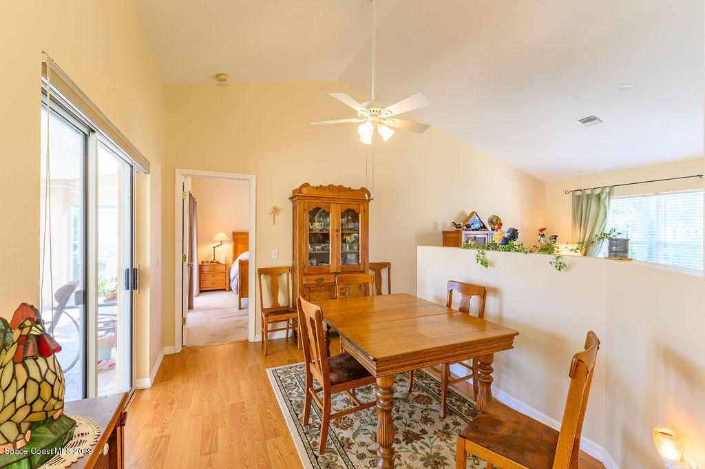 3525 Shady Run Road Melbourne, FL 32934 - Photo 13 of 32 a dining room with furniture and a chandelier