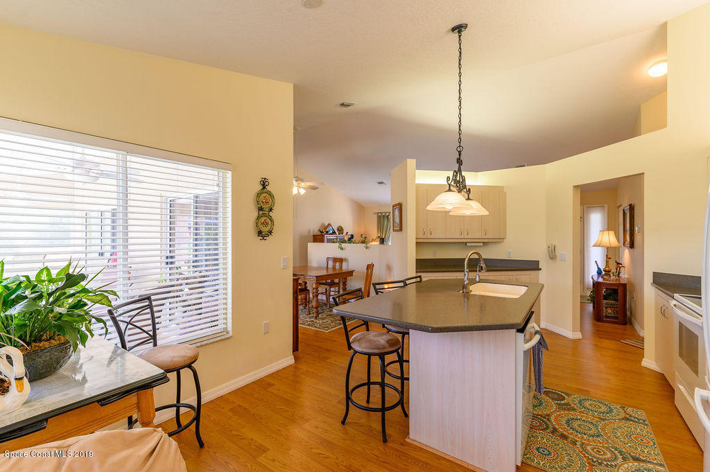 3525 Shady Run Road Melbourne, FL 32934 - Photo 15 of 32 a dining table chairs and a chandelier
