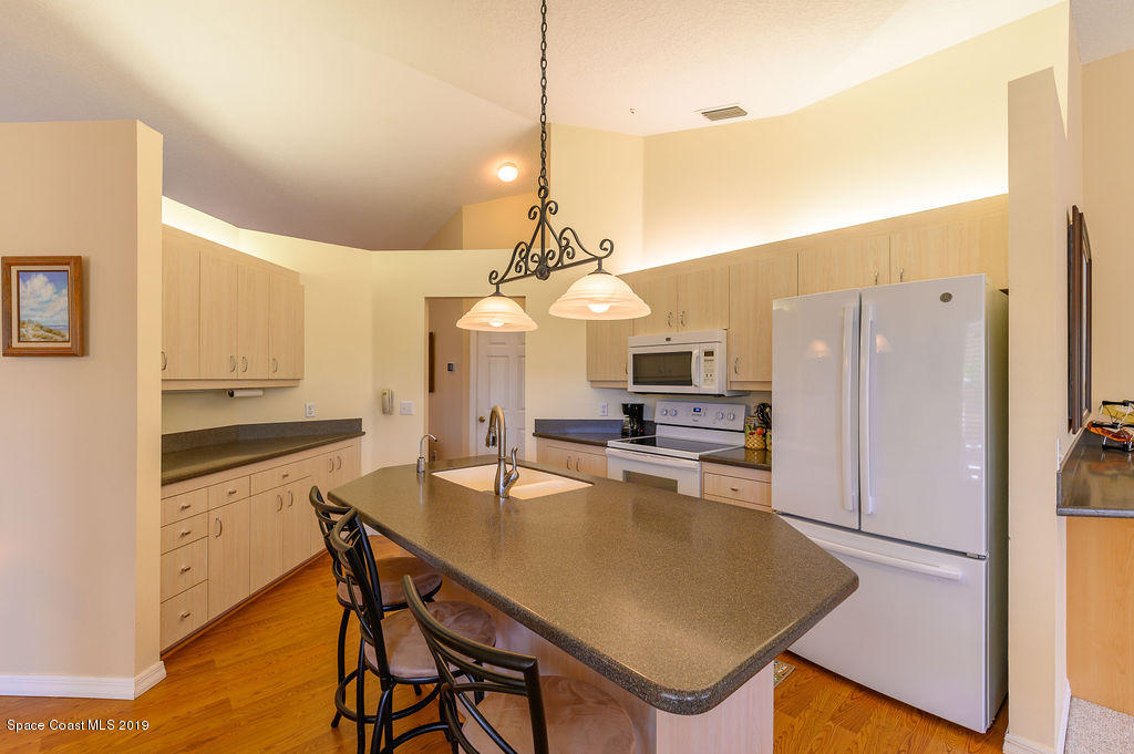 3525 Shady Run Road Melbourne, FL 32934 - Photo 16 of 32 a kitchen with stainless steel appliances granite countertop a stove a sink a refrigerator and a refrigerator