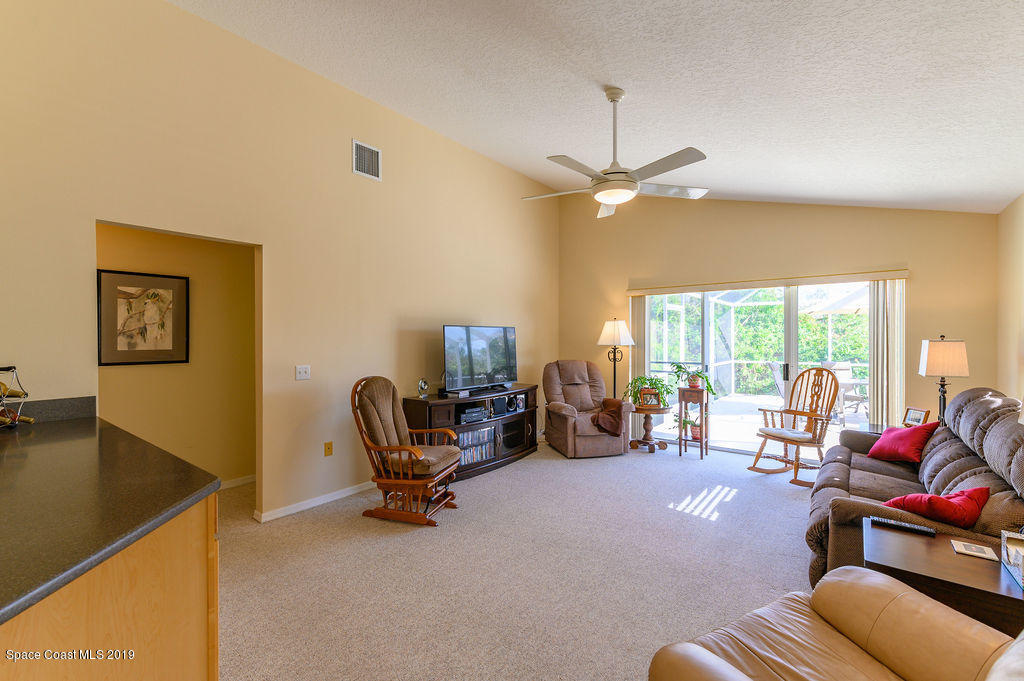 3525 Shady Run Road Melbourne, FL 32934 - Photo 17 of 32 a living room with furniture a flat screen tv and a large window