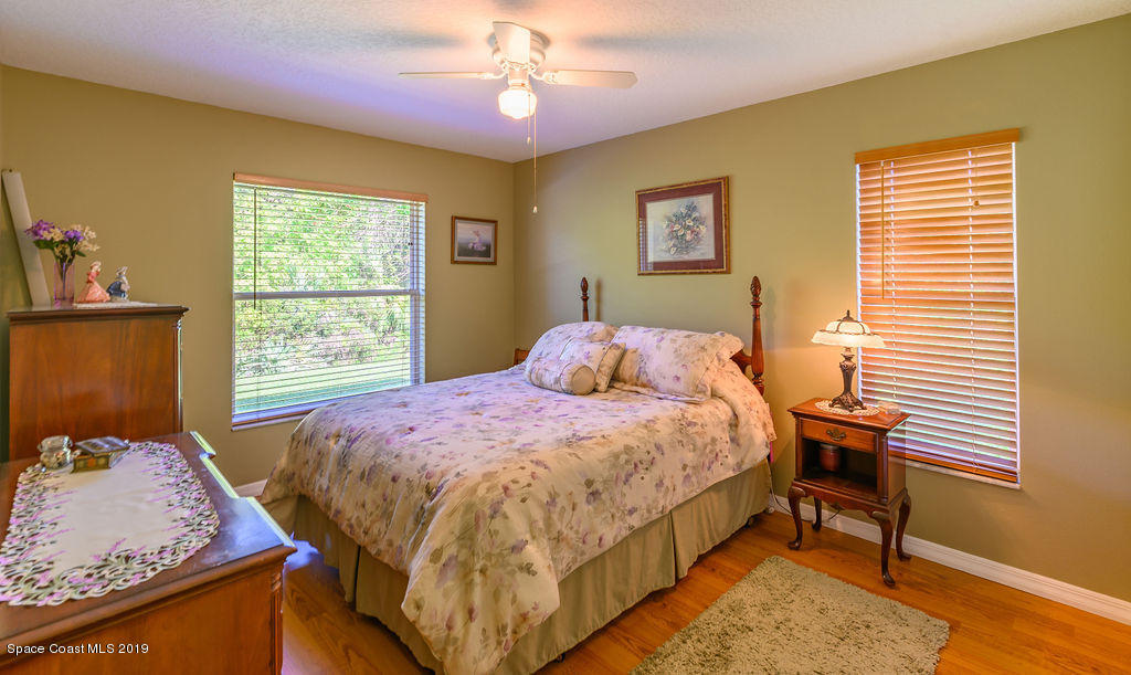 3525 Shady Run Road Melbourne, FL 32934 - Photo 19 of 32 a bedroom with a bed and a window