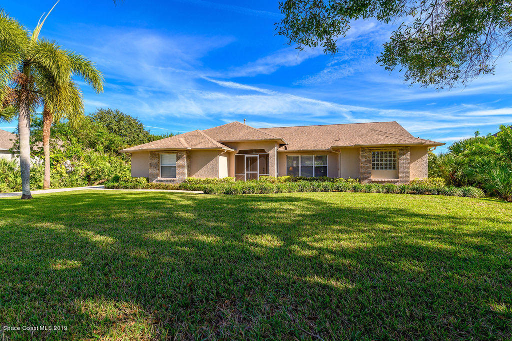 3525 Shady Run Road Melbourne, FL 32934 - Photo 3 of 32 a front view of a house with a yard