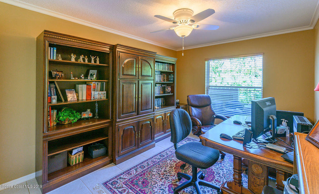 3525 Shady Run Road Melbourne, FL 32934 - Photo 22 of 32 a living room with furniture a rug and a window
