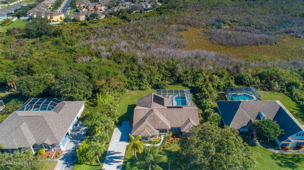 3525 Shady Run Road Melbourne, FL 32934 - Photo 4 of 32 an aerial view of a house with garden space and lake view