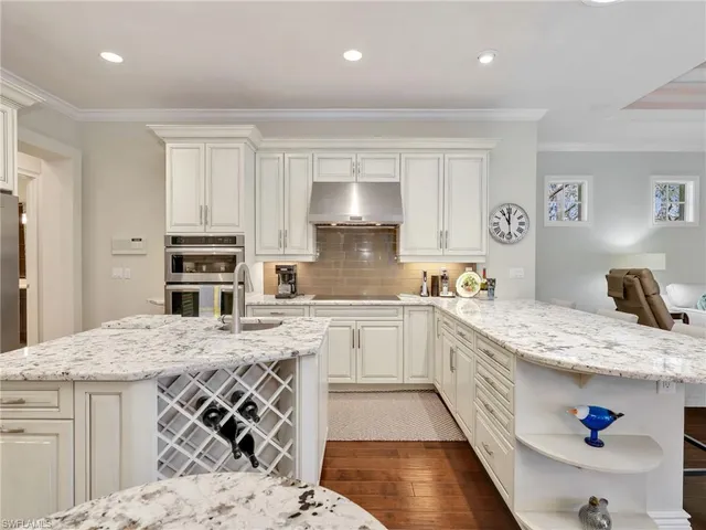 a kitchen with a stove a sink a microwave and cabinets