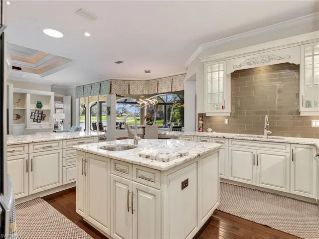 a kitchen with a sink stove and cabinets
