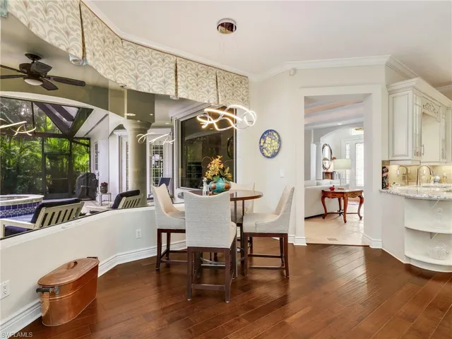 a dining room with furniture and wooden floor